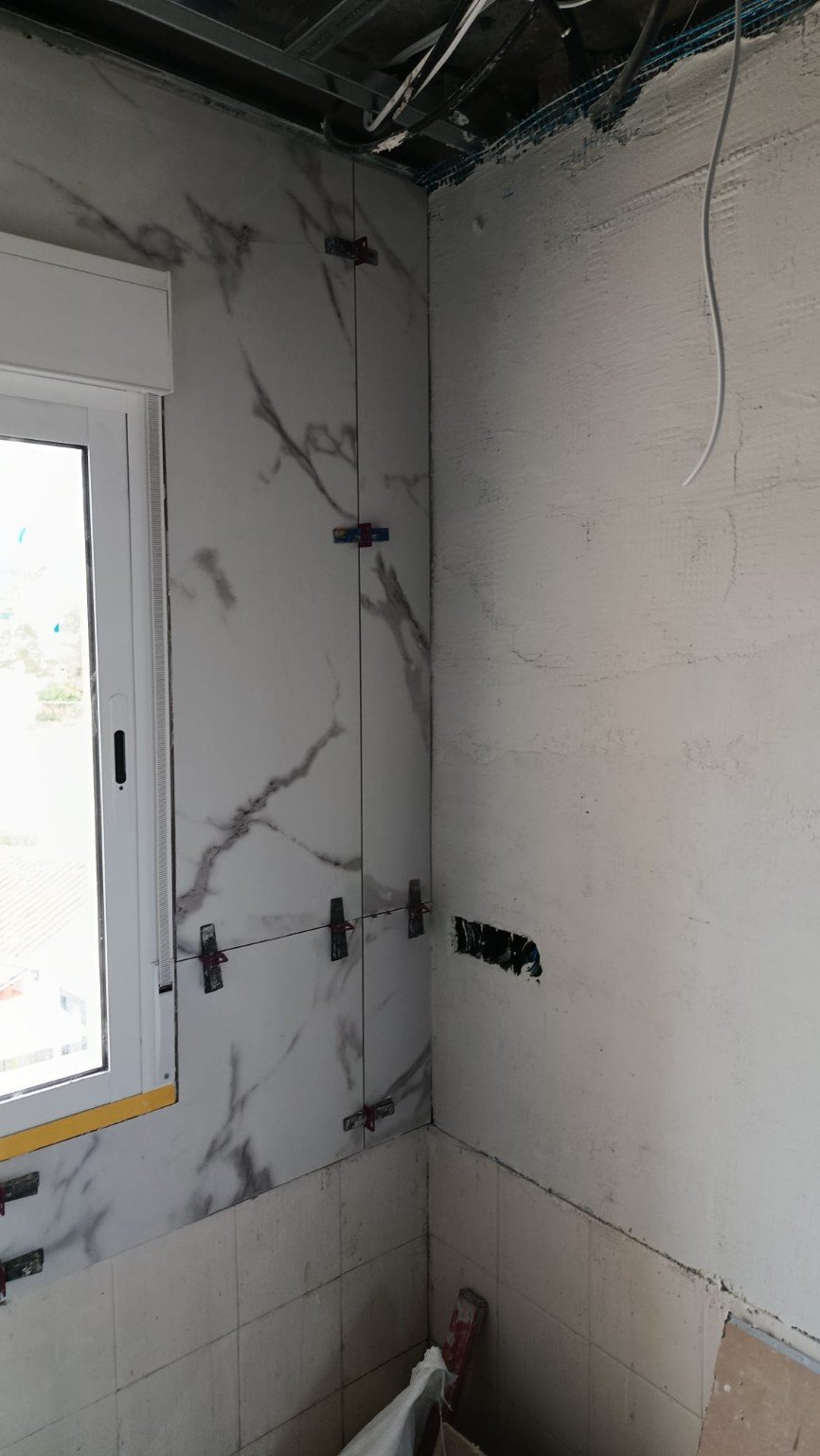 Bathroom wall tile installation in progress