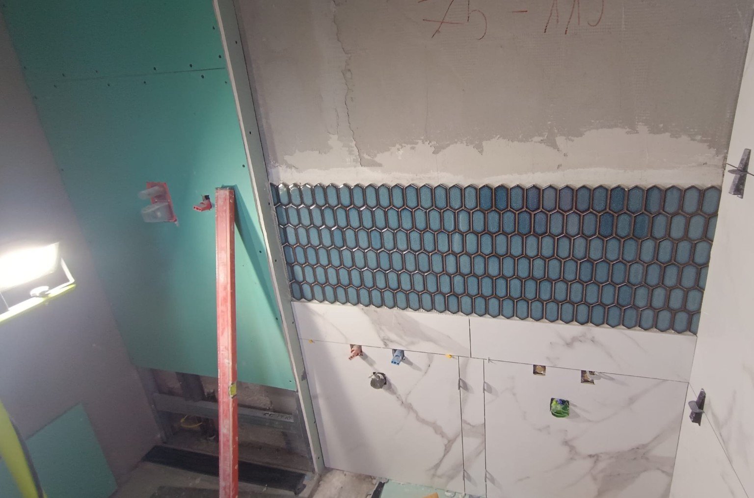 Mosaic tile installation in progress